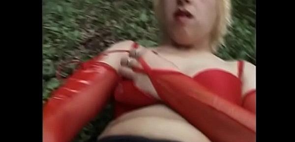  Nasty mature blonde in red putfit Adriana was lieing about exhausted on the grass after longstanding masturbation with dildo